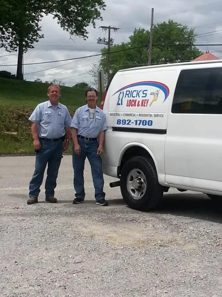 Rick's Lock & Key technicians beside a marked mobile unit